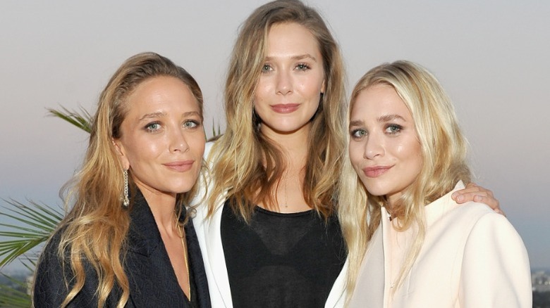 Mary-Kate, Elizabeth, and Ashley Olsen pose together