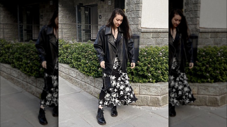 A woman wearing a dress with a leather jacket