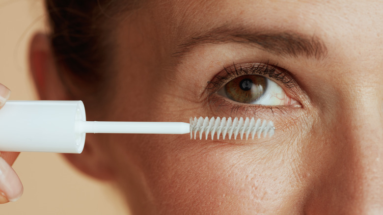woman applying clear mascara