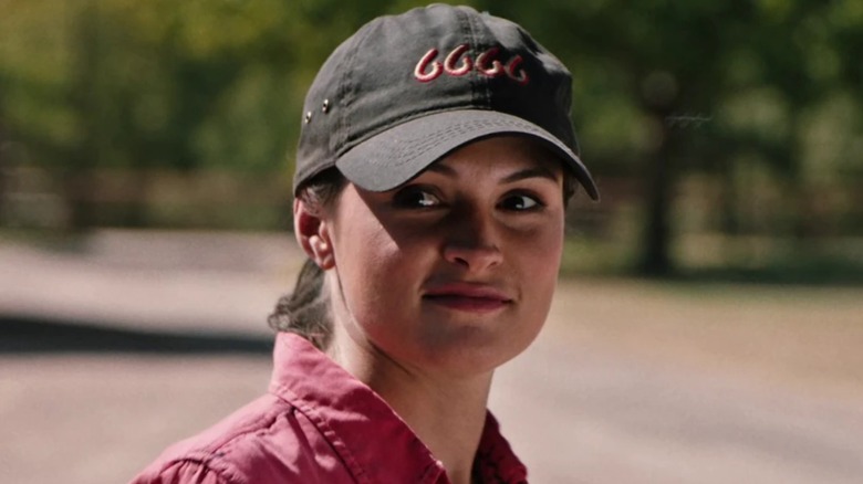 Emily (portrayed by Kathryn Kelly) wearing a pink shirt and wearing a black cap on "Yellowstone"