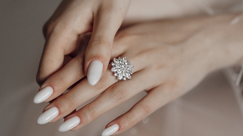 A woman wearing a large diamond ring which someone people may find uncomfortable and regret