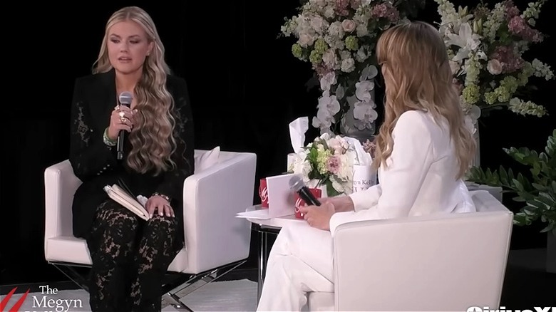 Erika Kirk speaks into a microphone during an on-stage interview