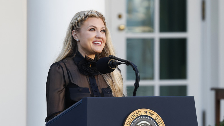 Erika Kirk speaks at a podium while at the White House