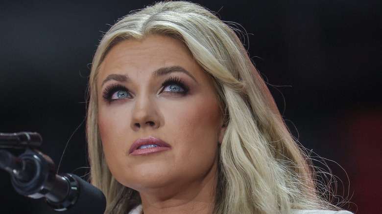 Erika Kirk speaking at a podium in 2025