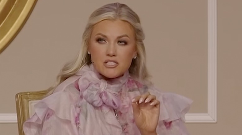 Erika Kirk waving while walking to a podium to give a speech