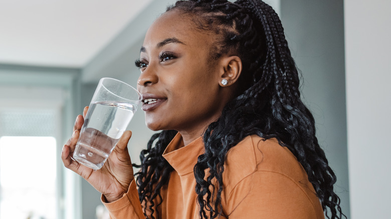 Beautiful woman drinking water