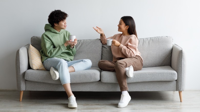 Couple talking on couch
