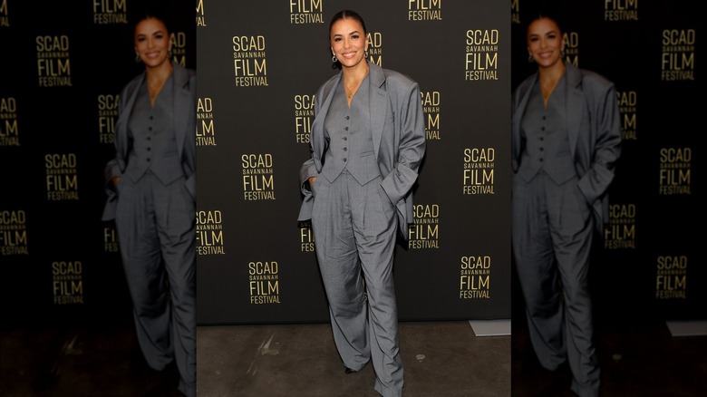 Eva Longoria smiling in a suit