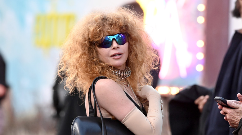 Natasha Lyonne with big, bouncy '80s-inspired curls and sunglasses