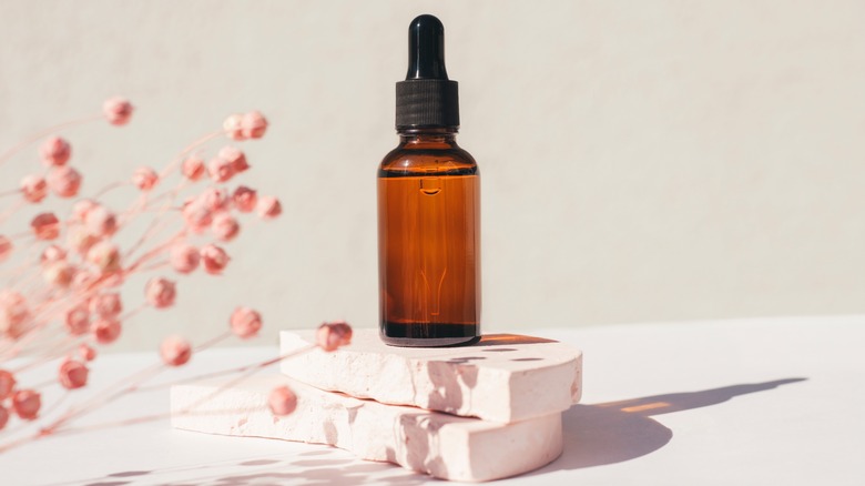 A bottle with a dropper containing a plant-based oil