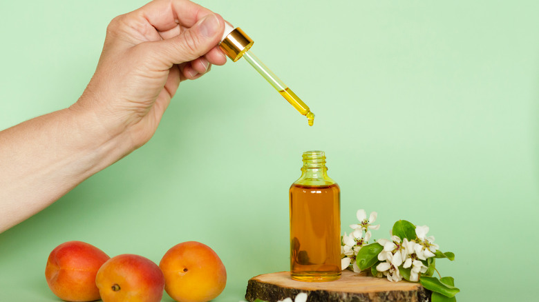 person dispensing apricot oil