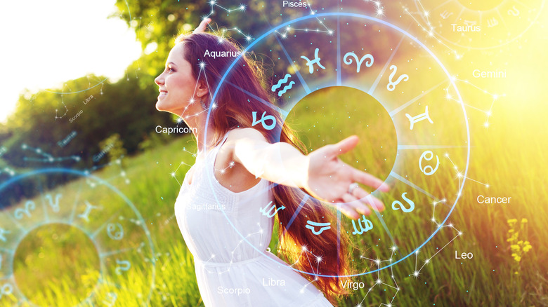 woman arms out with zodiac wheel 