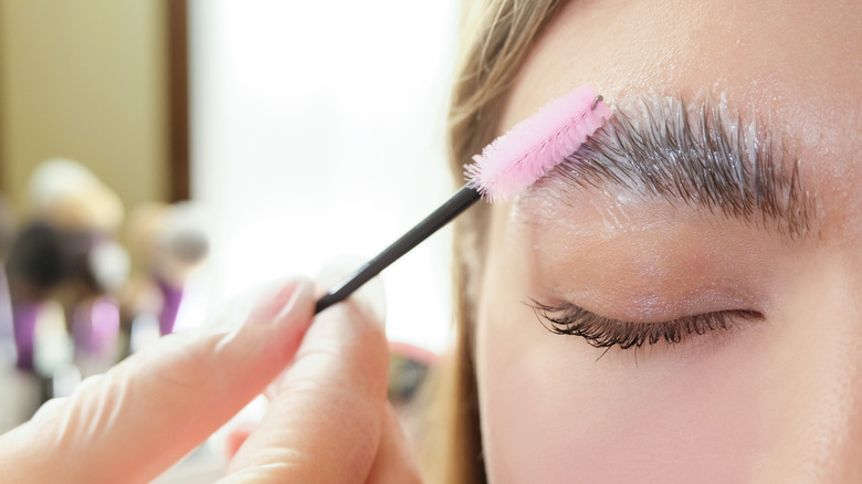 A woman getting her eyebrows laminated