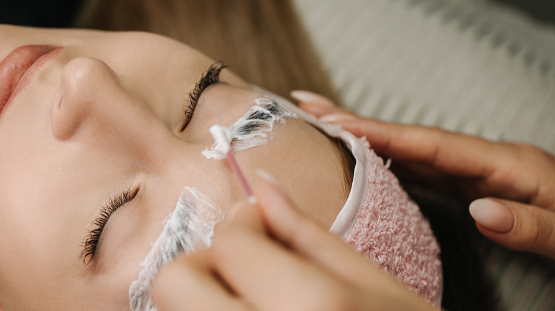 A woman getting her eyebrows laminated