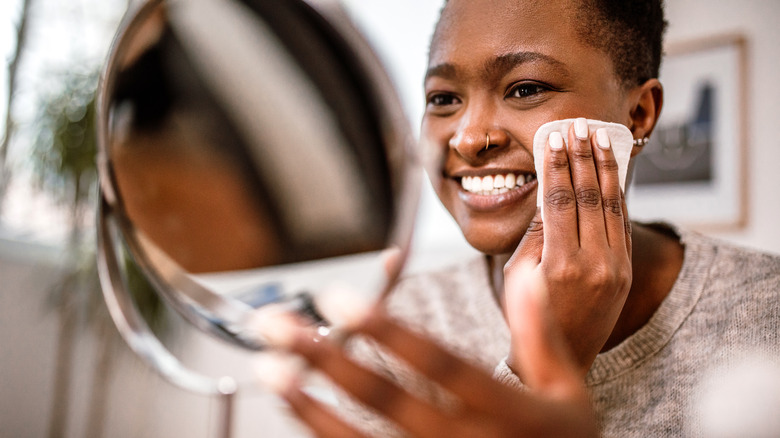 A woman taking her makeup off