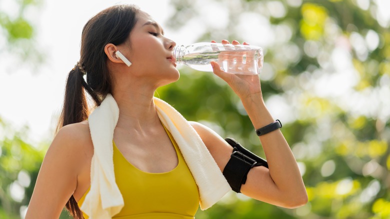 Brunette woman drinking water