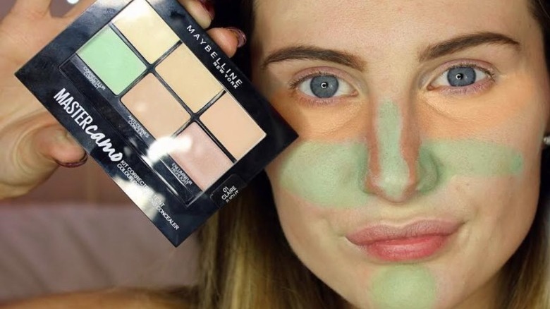 Woman with color correcting concealer on her face