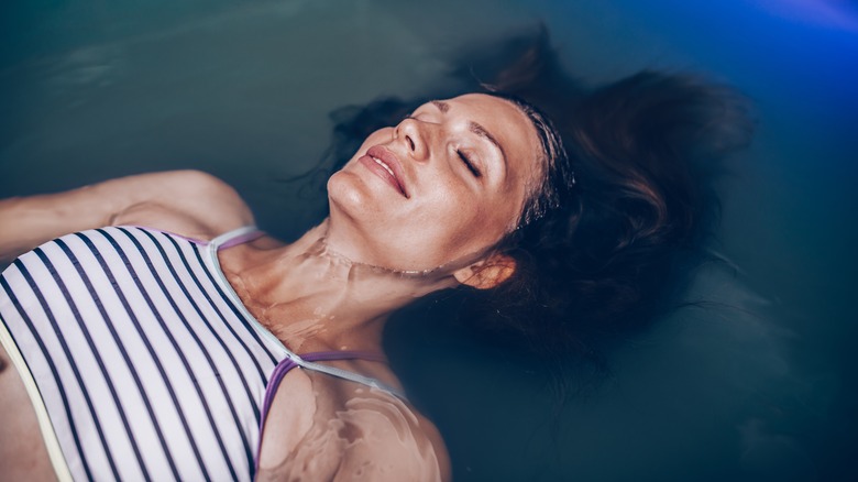 Woman floating inside float tank