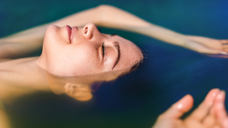 Woman inside a float tank 