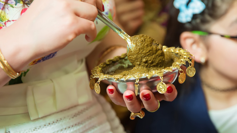 person mixing henna
