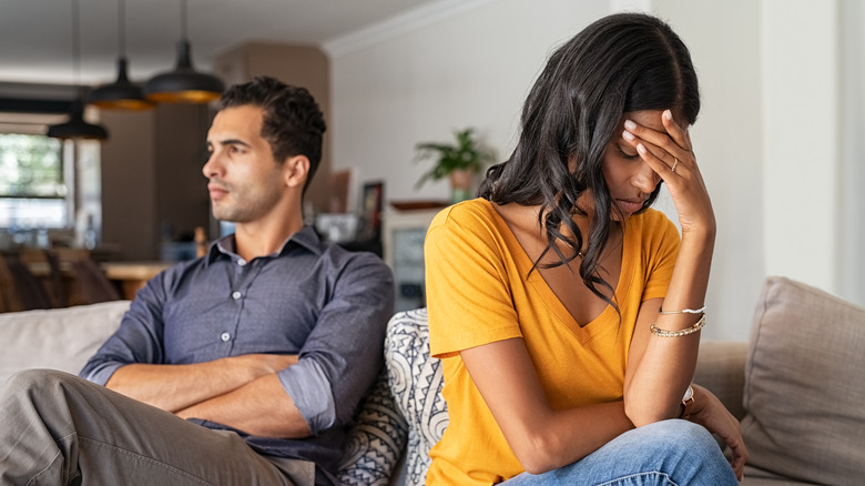 couple fighting on couch
