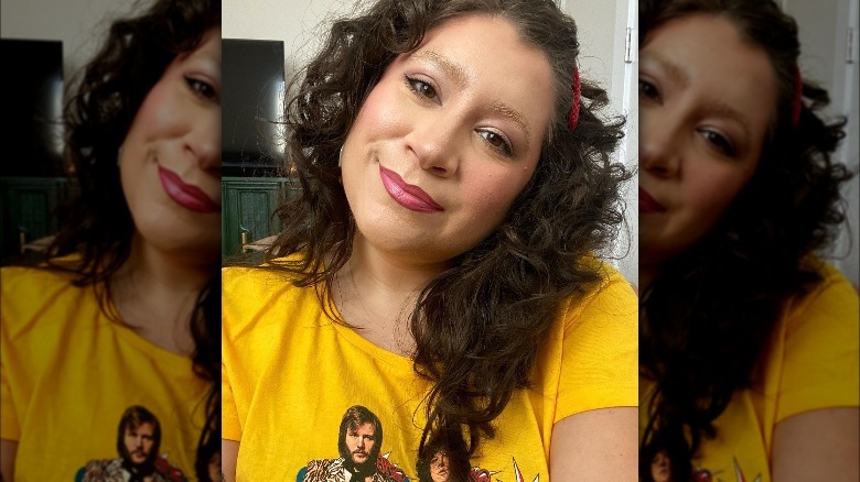 Woman with dark hair and bleached eyebrows