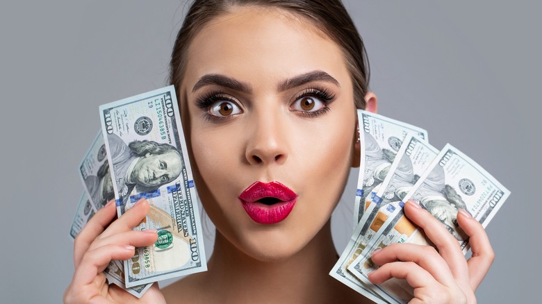 A woman holding money