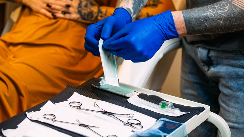 professional preparing for piercing