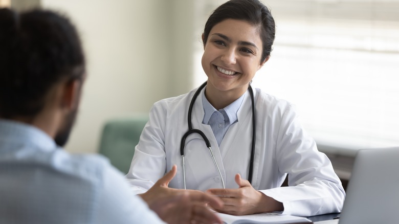 Female doctor talking to patient