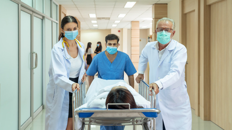 Doctors wheeling patient into surgery