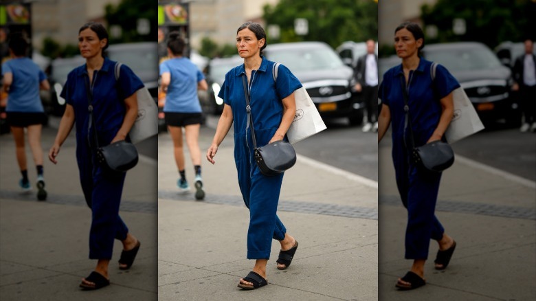 Person in jumpsuit and sandals