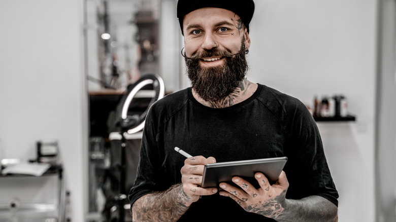 Piercer standing in shop