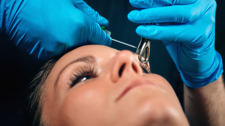 Piercer piercing an eyebrow