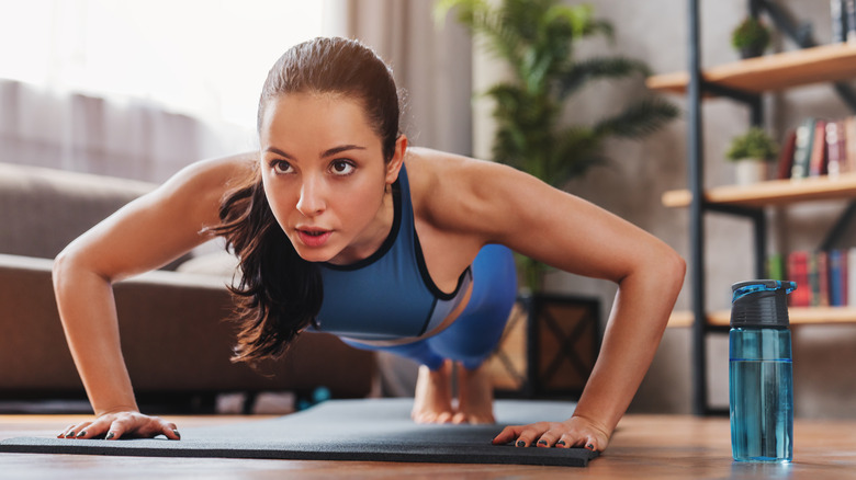 Woman doing pushups in living room