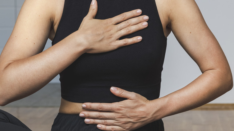 woman doing diaphragm breathing exercise
