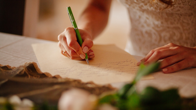 bride writing her wedding vows 