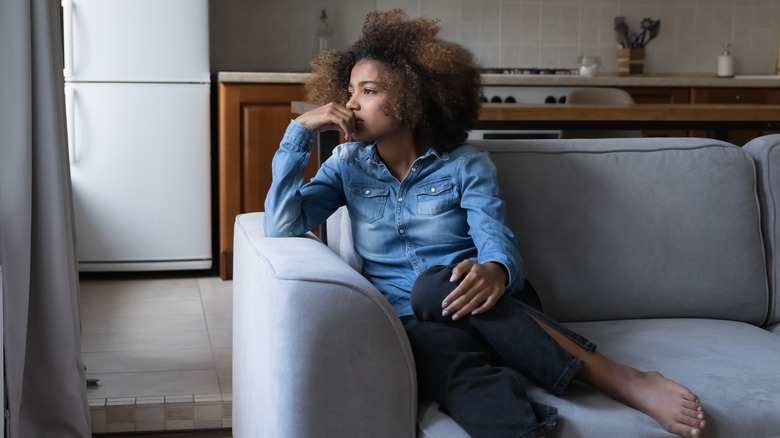worried woman on sofa