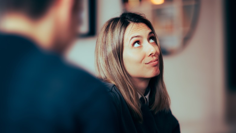 Woman rolling eyes at partner