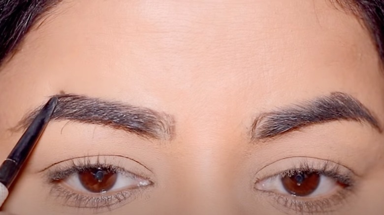 Woman filling in brow