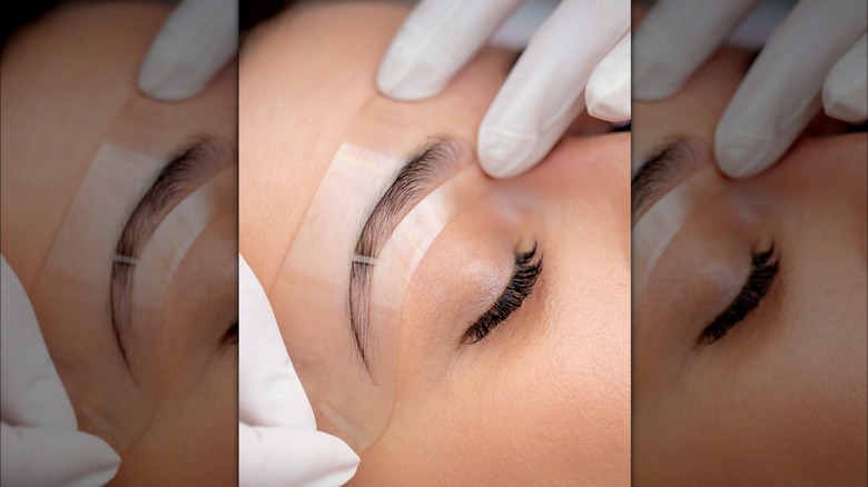 Person with eyebrow stencil on face