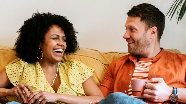 Man and woman chatting on sofa