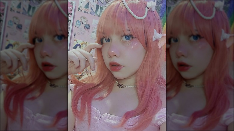 woman with pink hair and makeup