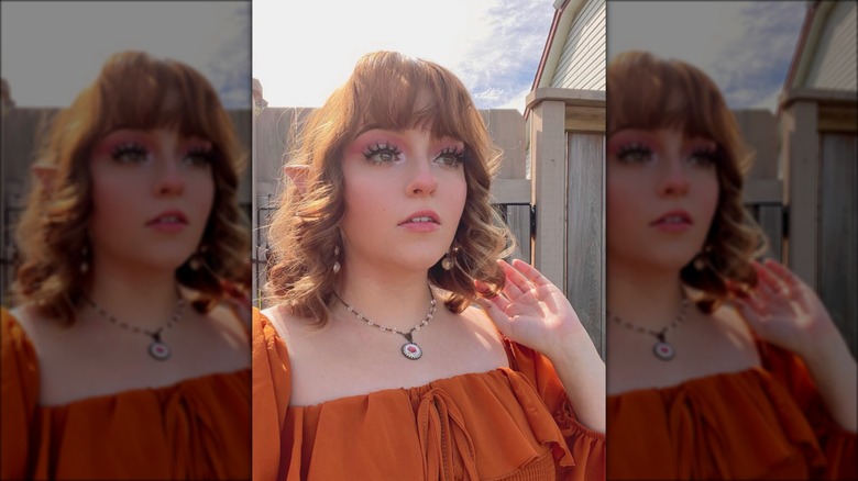 woman with elf ears and long lashes