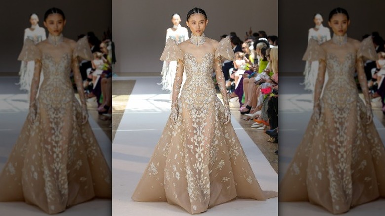 Model wearing sheer wedding dress