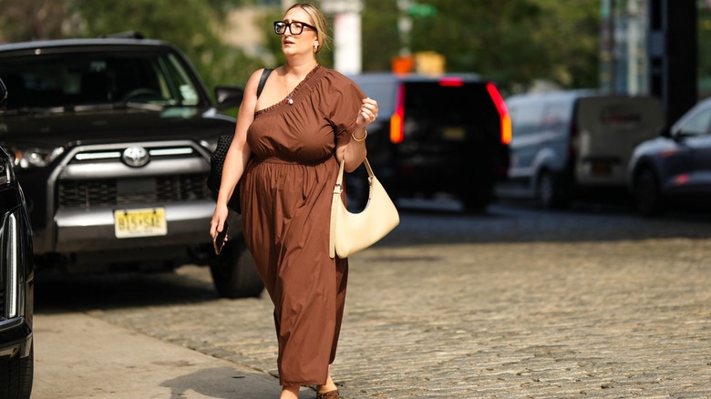 Woman wearing asymmetrical off-the-shoulder dress