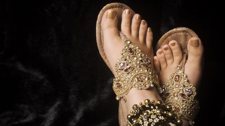 Fancy gold flip-flops, matching pedicure