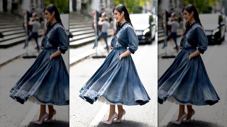 A woman wearing a blue outfit and heels at fashion week