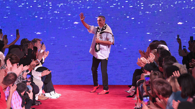 Raf Simons waves at the crowd