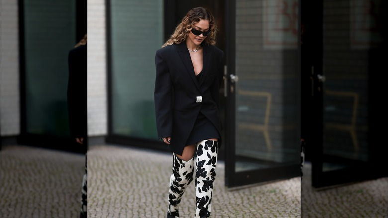 woman wearing blazer with metal piece