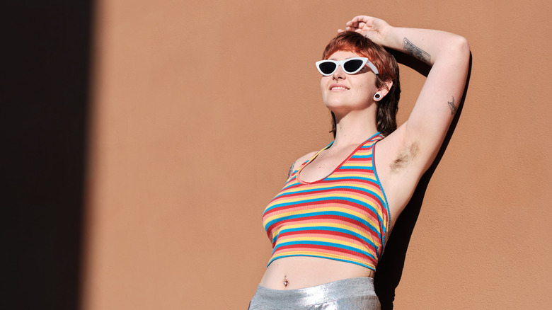 woman shows armpit hair